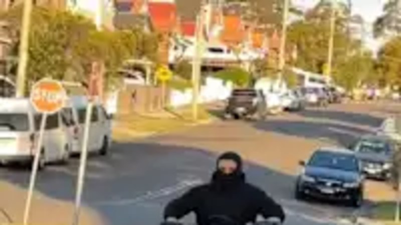 A 14-year-old boy riding his e-bike without a helmet.