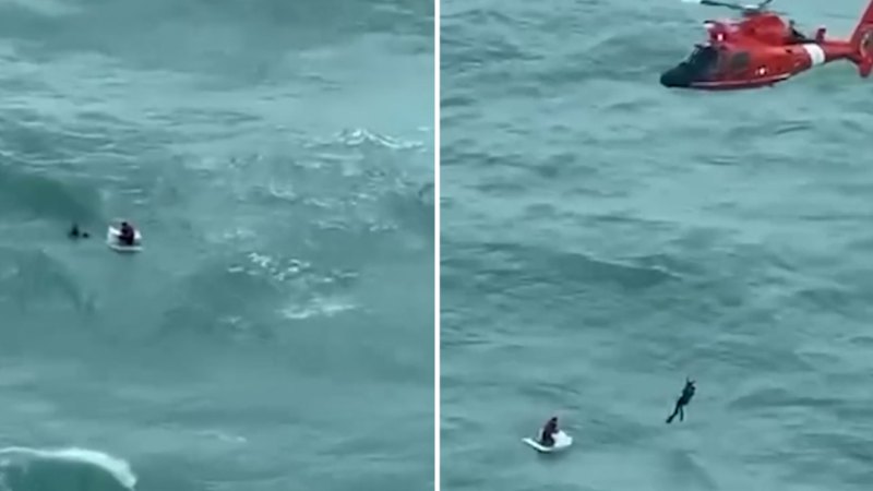 US Coast Guard rescue man clinging to esky in ocean