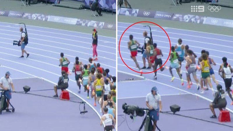 Cameraman walks onto athletics track