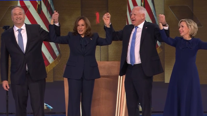 Kamala Harris, Doug Emhoff, Tim Walz and Gwen Walz hold hands