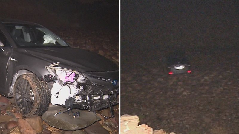 Sedan plunges over 20m cliff onto rocky beach