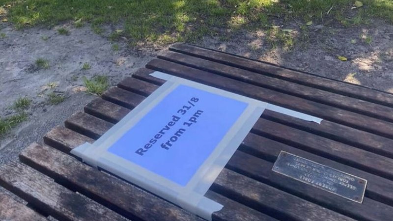 Sign on beachside picnic table divides local community