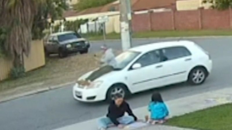 Passenger caught on camera riding on car bonnet