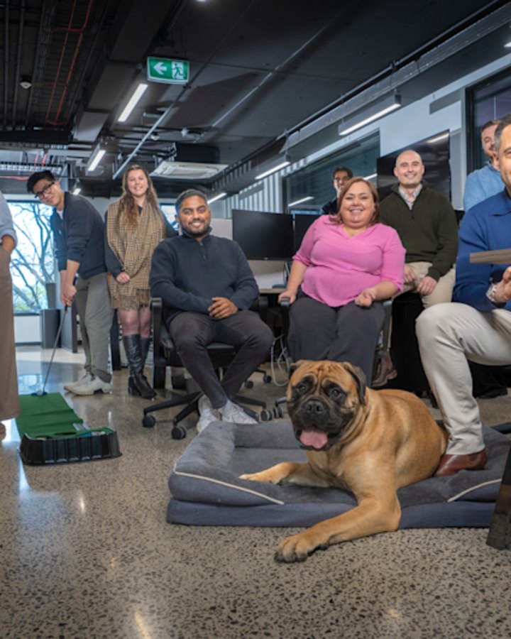 Anthony Alabakov (blue shirt), CEO of My Mortgage Freedom, with staff and his dog Harley.
