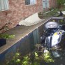 A family in Sydney's south-west were asleep last night when a car smashed through their fence and into their backyard pool.