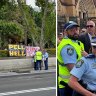 Protesters clash with Catholic faithful outside Cardinal Pell’s funeral