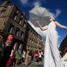 Fringe performers promote their shows on Edinburgh's Royal Mile.