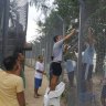Manus Island: locals are 'looting the camp', detainees claim
