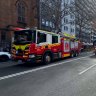 Fire and Rescue NSW vehicles protest with sirens blaring in Sydney