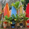 A colourfully painted surfboard fence.