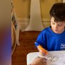 Lisa Price of Love2Learn teaches a boy, 6, the fundamentals of handwriting.