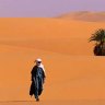 Well-trodden route ... walking in the dunes of the Libyan Sahara.