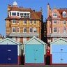 Coast and country charm ... townhouses dwarf quaint seaside huts on Brighton Beach. 