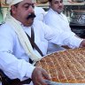 A Syrian worker prepares sweets a week before the holiest days of the Muslim calendar