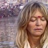 Hollywood actress Goldie Hawn, right, meditates in a boat in Varanasi, India, Monday, Nov. 9, 2009. 