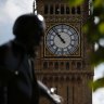 The statue of former British Prime Minister David Lloyd George is silhouetted against the Queen Elizabeth Tower which holds the bell known as 'Big Ben' in London.
