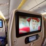 Entertainment system screens inside the cabin of a Emirates Boeing 777.