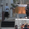 Clergy and parishioners react to the armed teen in the back of the church during the mass held in a Catholic church in Louisiana.