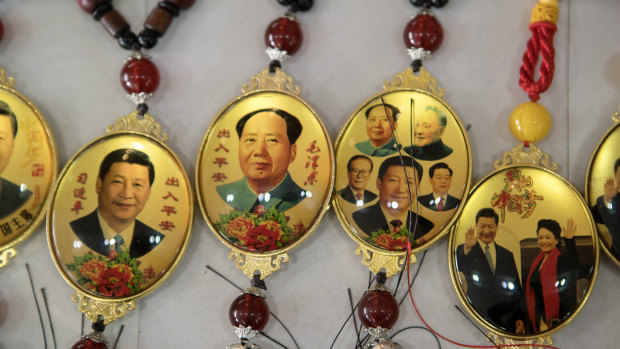 Souvenirs in Beijing featuring portraits of former Chinese leader Mao Zedong and Chinese President Xi Jinping.