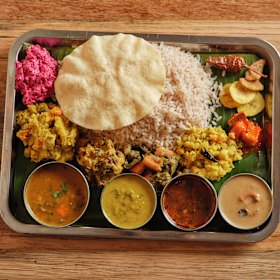 Babaji’s sadhya, a traditional dish of 12 different elements served on a banana leaf.