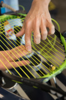Every frame is different: Australian Open stringer Pin Lay hand-threads a polyester string into a racquet frame.