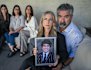James Tsindos’ family (left to right) sisters Elpida (in black), Kristina, and Georgia (in white)  mother Venetia (holding a picture of James) and father Harry Tsindos, at home. 17 year old James Tsindos died in 2021 after going to Holmesglen Private Hospital.