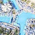 By day, interlocking pools, cabanas and daybeds are sought-after spots for relaxation.