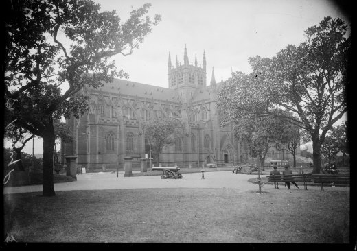 St Mary's Cathedral from under the trees of Hyde Park, Sydney, ca. 1928.