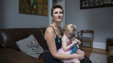 Caitlin Delany, who has stage four ovarian cancer, holding daughter Willow in their Sydney home.