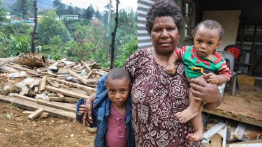 Pauline Johnson, 6, her mother Janette and brother Jford, 9 months, are living in temporary accommodation on the site where their two houses, home to four children and eight adults, were destroyed.