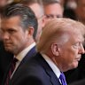 US President Donald Trump walks past War Secretary Pete Hegseth at the White House on Monday.