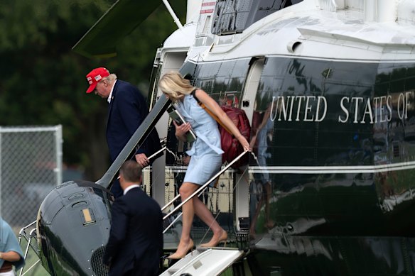 US President Donald Trump and Natalie Harp step off from Marine One on Sunday.