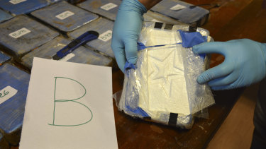 A police officer shows a package of cocaine with a star sign, that was found in an annex building of the Russian embassy in Buenos Aires in 2016.