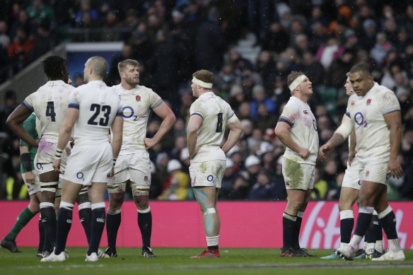 Defeated: England's players react after Ireland scored a third try.