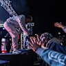 Spenny reaches out to fans as he performs at ONEFOUR’s album launch event at Sydney Dragway in Eastern Creek, in Sydney’s west on Thursday night.