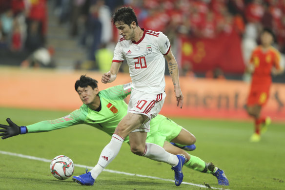 Iran's Sardar Azmoun scores his side's second goal against China.