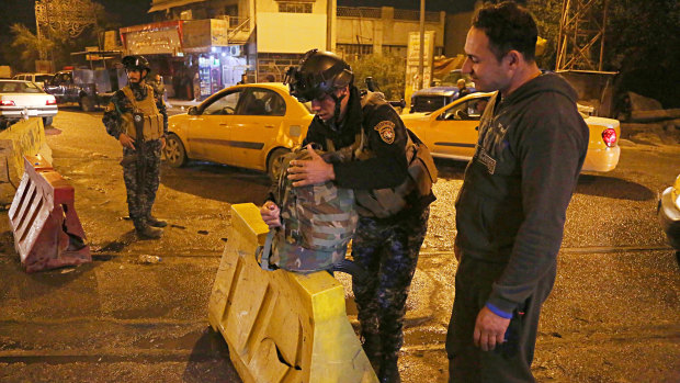 Iraqi security forces working at the scene of a suicide bombing in Baghdad.