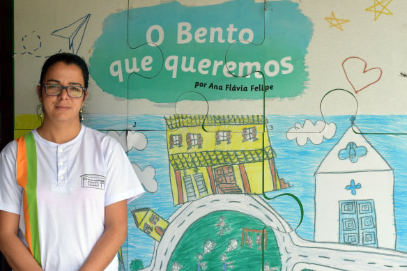 Eliene Geralda dos Santos, Bento Rodrigues' school principal, at the school's temporary premises in Mariana, in Brazil's Minas Gerais state in November.  In the background a student's drawing depicts "The Bento we wish for".