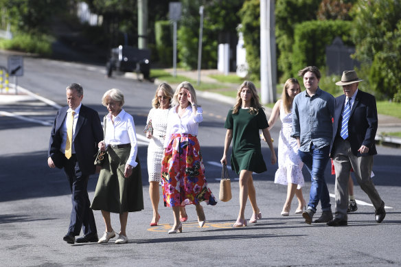 Chloe Shorten, in red skirt, attends an Easter service with (from left) Bill Shorten, mother Quentin Bryce, sister Revy Bryce-Browning, daughter Gigi, niece Alexandra Browning, son Rupert and father Michael Bryce.