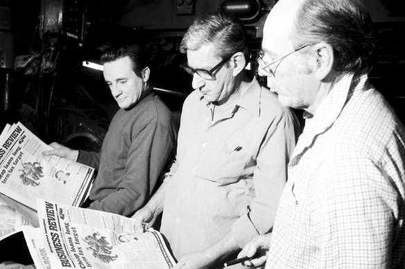 (Left to right) Bob Dempsey (National Times production editor), Evan Whitton (editor) and Vic Carroll have a look at the first printing of the National Times Business Review at John Fairfax in Sydney's Broadway on 6 September, 1980.