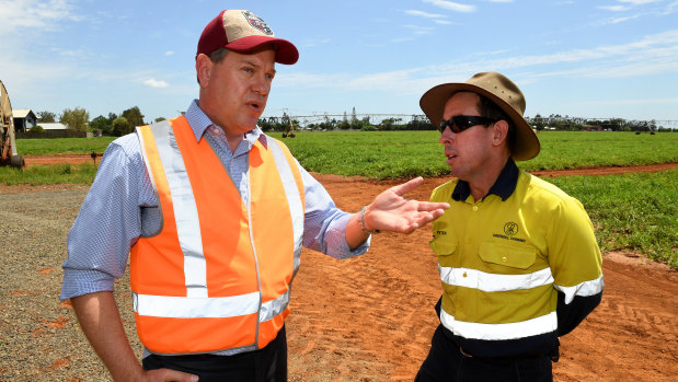 Queensland Opposition Leader Tim Nicholls (left) chats to sweet potato and watermelon farmer Peter Greensill on his farm in Bundaberg.