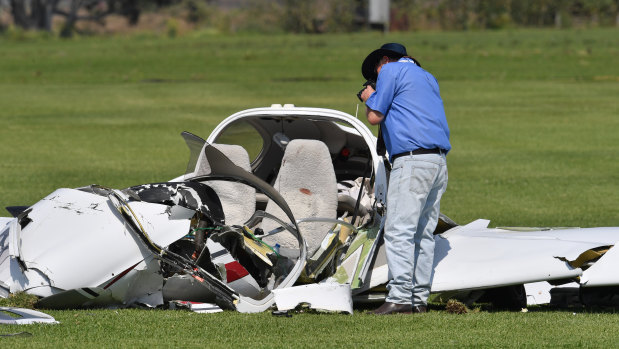 An investigator looks over the wreckage at the scene of a light aircraft crash at Allenview on Tuesday.