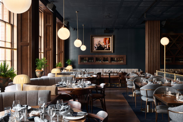 Plush booths, rich blue walls and globe lights in The Sanderson dining room.