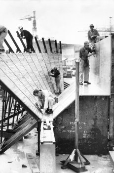 Carpenters work on the wooden moulding for part of the Opera House roof in 1963.