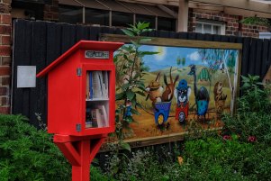 The little library and a Brigitte Dawson painting in Laz's Lane.