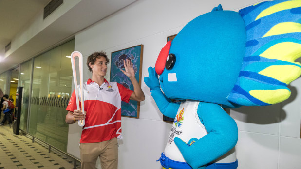 Cameron McEvoy arrives with the Queen's baton alongside Commonwealth Games mascot Borobi.