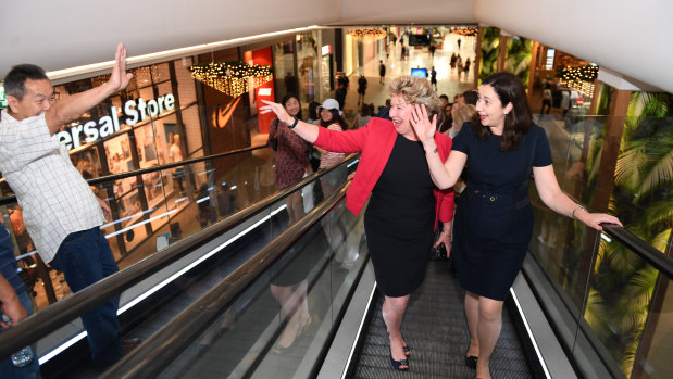 Premier Annastacia Palaszczuk and Mansfield electorate candidate Corrine McMillan wave to a shopper in  a last-minute visit to the electorate on Friday.