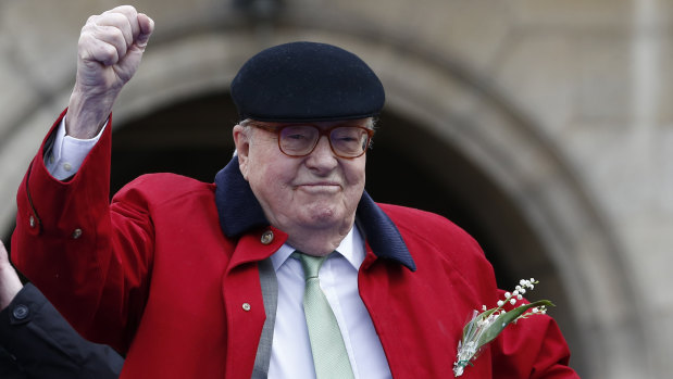 National Front founder Jean-Marie Le Pen clenches his fist at the statue of Joan of Arc in Paris last year.