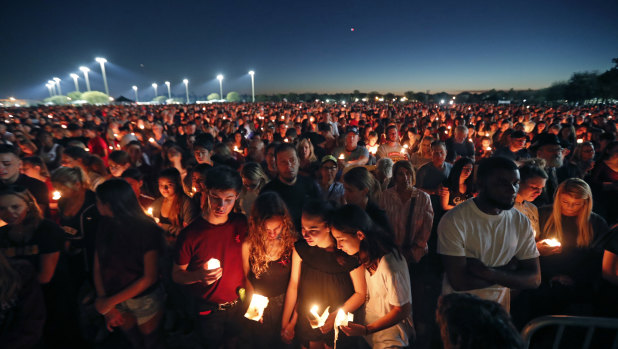 People attend a candlelight vigil for the victims of the Wednesday shooting at Marjory Stoneman Douglas High School, in Florida.