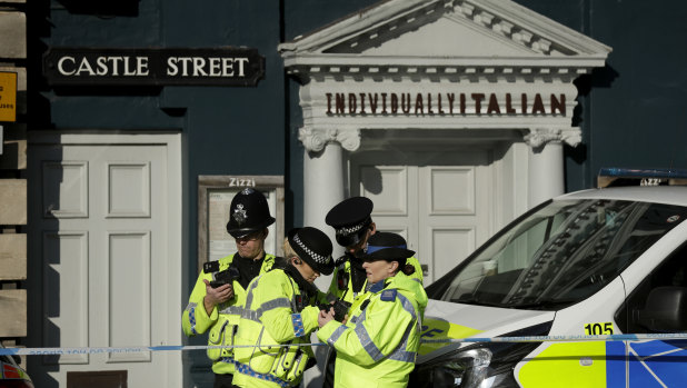 Police officers stand outside a Zizzi restaurant. Investigators are trying to determine how Skripal was poisoned.